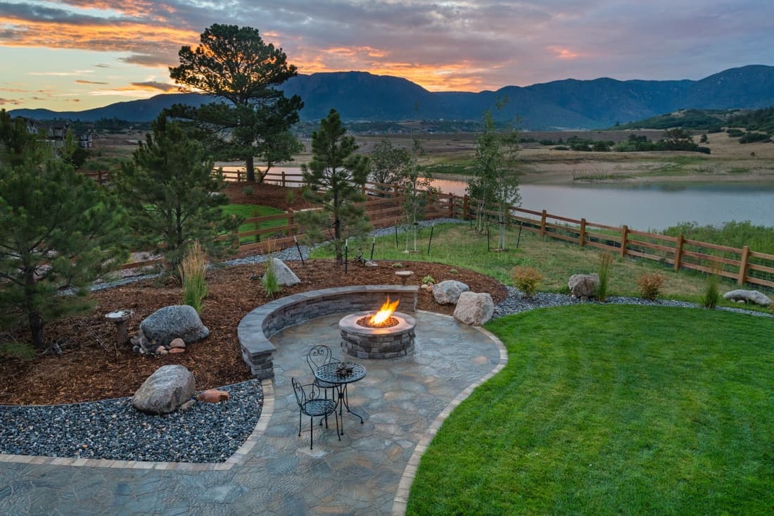 Attractive rural landscaping scene with plantings and fire pit