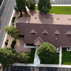 Property managment aerial photo of a church with lawns and trees