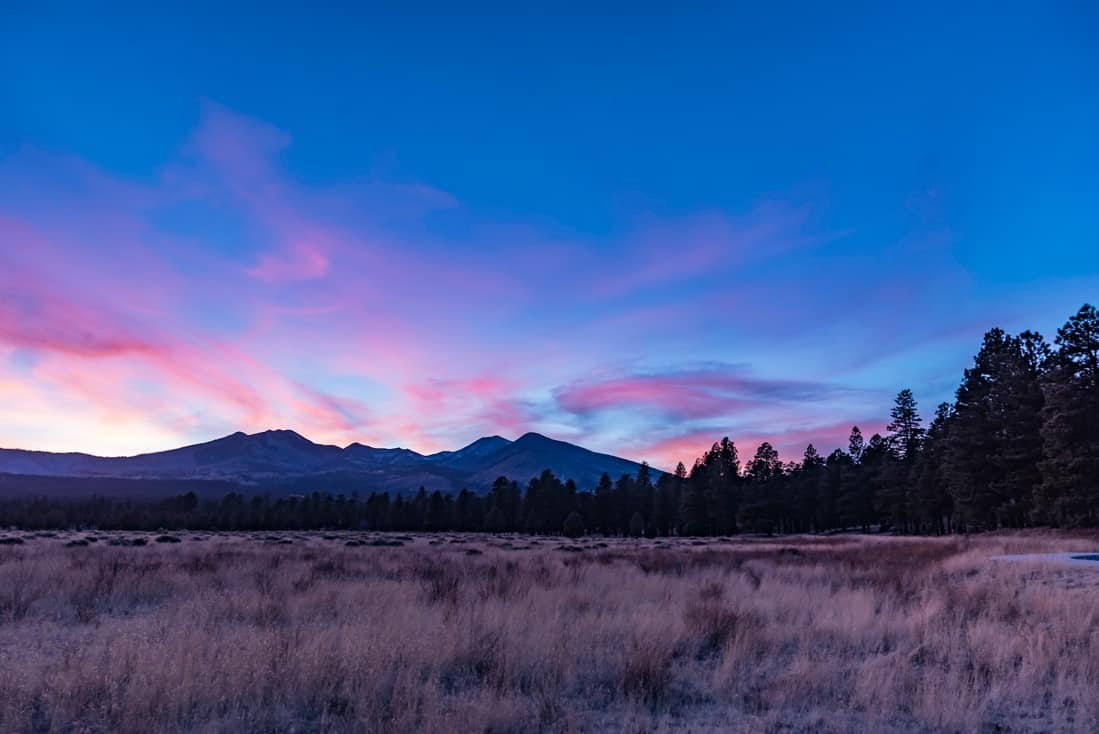 Beautiful natural landscape with the sun setting behind mountains